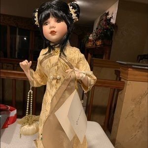 “Ming” porcelain China doll on stand.